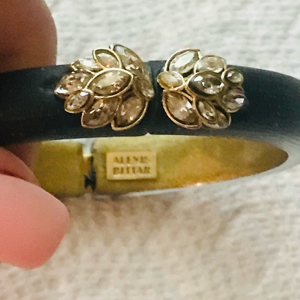 Alexis Bittar black lucite hinged bracelet with crystals in gold tone setting.